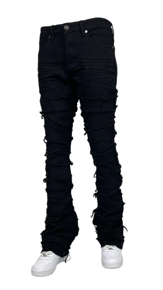 Men’s distressed stacked jeans in black wash with heavy shredded detailing and layered denim texture