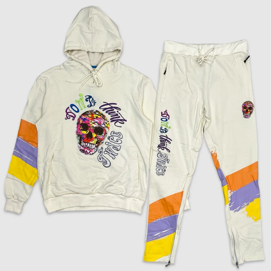 Cream hoodie and jogger set with multicolor skull graphic and 'Don't Think Twice' text, featuring orange, yellow, and purple paint stripe accents – bold urban streetwear outfit.