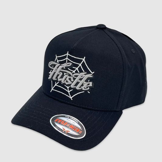 Black snapback hat with embroidered Hustle text and spiderweb design