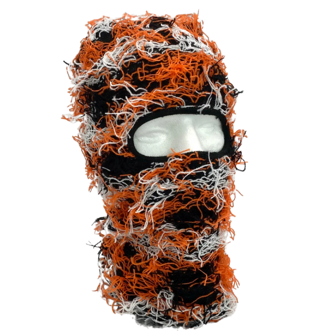 Orange Black White knitted balaclava with orange, black, and white pattern on a white background