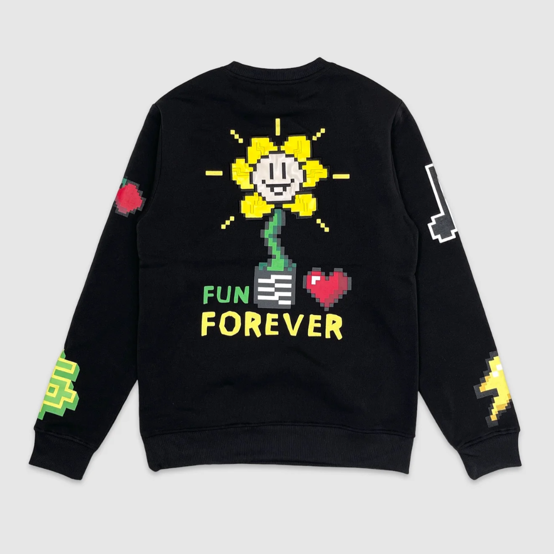 Back of Black crewneck sweatshirt with retro pixel art graphics, featuring a smiling yellow flower, star, cherries, snake, and bold red VS Fun text – playful vintage gaming style streetwear.