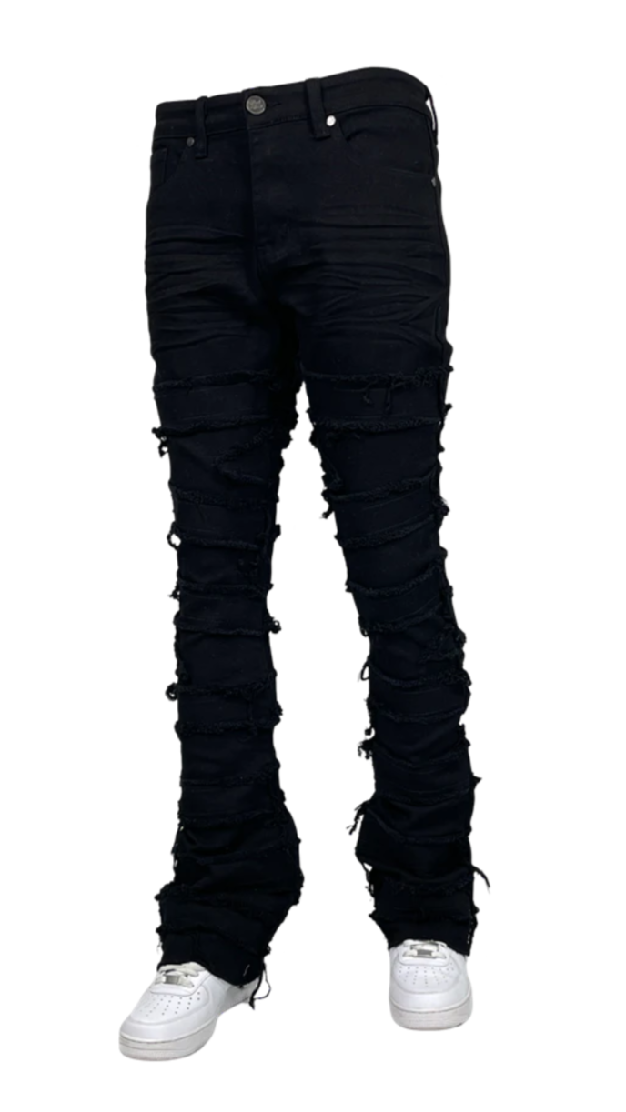 Men’s distressed stacked jeans in black wash with heavy shredded detailing and layered denim texture