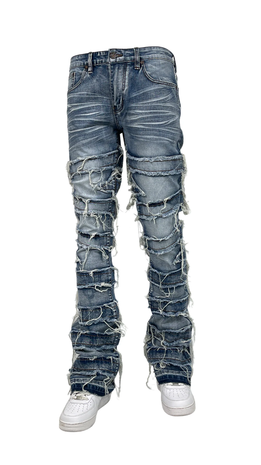 Men’s distressed stacked jeans in dark blue wash with heavy shredded detailing and layered denim texture