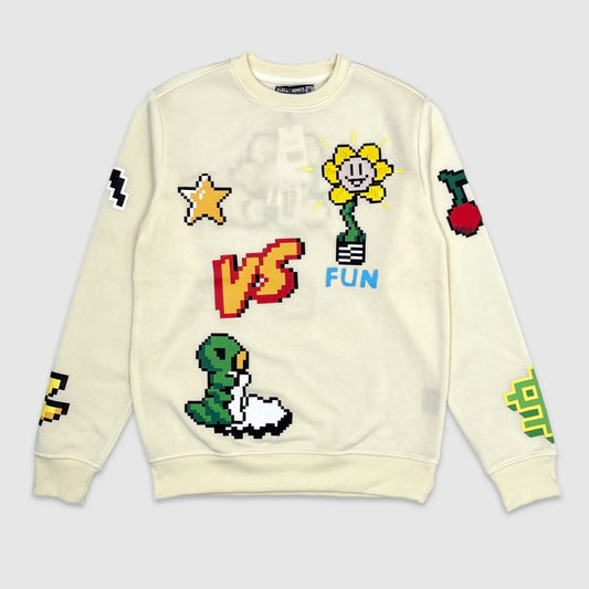 Beige crewneck sweatshirt with retro pixel art graphics, featuring a smiling yellow flower, star, cherries, snake, and bold red VS Fun text – playful vintage gaming style streetwear.