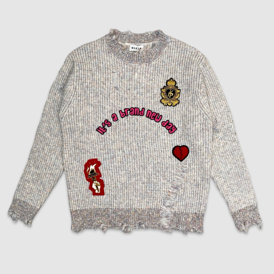 Grey distressed knit sweater with embroidered 'Peace', 'Love to Keep' text, and yellow crown patch – men’s urban fashion by City Grid Apparel